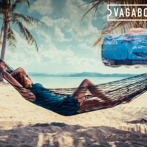 Woman relaxing in hammock on tropical beach